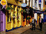Two men walk past shops in Temple Bar area.