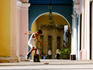 Boy rollerblading in arcade of Plaza Vieja, Habana Vieja.