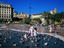 Children playing with pigeons in Catalunya Square.