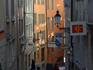 People walking down a small cobble-stoned alley lined with restaurants, bars and shops, Niederdorf (old town).