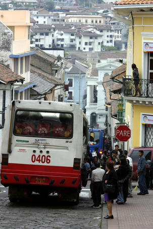 Large bus in narrow street.