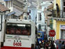 Large bus in narrow street.