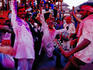 Roving band of musicians performing to an audience in Durbar Square during Holi (festival of colour).