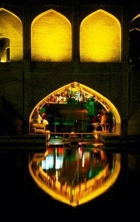 Teahouse under arch of Si-o-Seh Bridge reflected in Zayandeh River.
