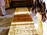 Visitor reading calligraphic script on Tomb of Sa'di.