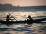 Two boys in an outrigger canoe near the wave called Hollow Trees or Lance's Right.