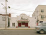 Car passing theatre.