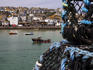 Lobster pots and fishing boats in St Ives harbour.