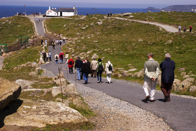 People strolling a coastal path.