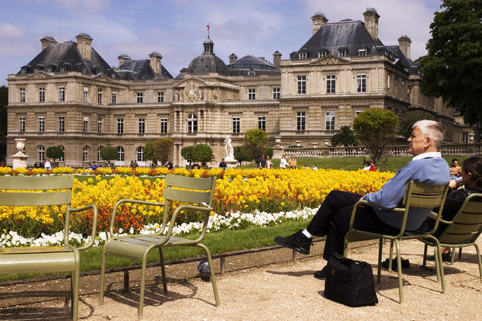 People relaxing in chairs in Jardin du Luxembourg.