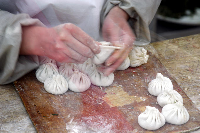 Chef making famous Tianjin Gou-Bu-Li buns in a restaurant.