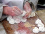 Chef making famous Tianjin Gou-Bu-Li buns in a restaurant.