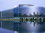 European parliament building reflected in river.