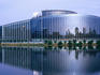 European parliament building reflected in river.