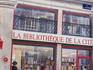 Walking past mural of bookshop.