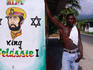 Man standing next to mural of King Selassie I.