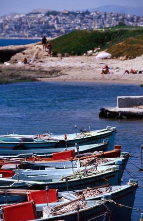 Palaio Faliro, boats in foreground with beach and city in distance, Mediterranean.