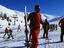 People at beginning of ski runs at resort.