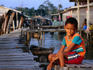 Boy sitting on a pier in Kampung Bugis.