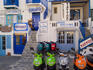 Motorbikes parked outside shops.