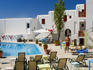 People sunbathing by a swimming pool.