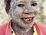 Portrait of Makua woman with nciro paste on her face.