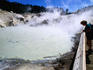 Visitor on boardwalk looking at fumaroles, Bumpass Hell.