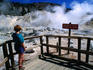 Visitor on boardwalk looking at fumaroles, Bumpass Hell.