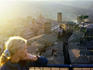 Woman looking over rooftops at sunset.