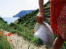 Woman on Cinque Terre pathway near coast.