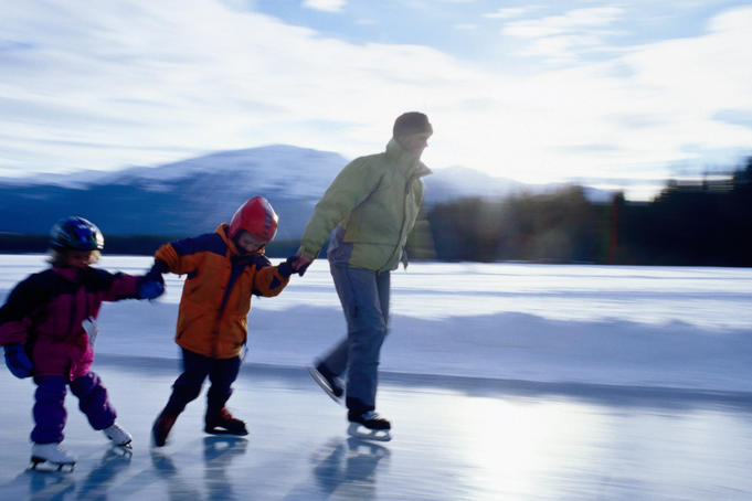 Family skating on frozen lake.