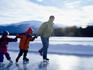 Family skating on frozen lake.