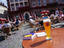 People relaxing in outdoor cafe with glass of Heidelberger Weizenbier and Germany Lonely Planet guidebook on table in foreground, Marktstube, Marktplatz 4.