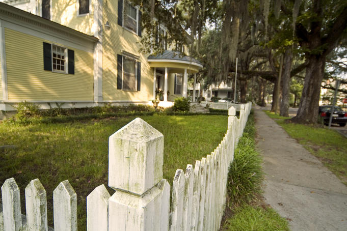 Fence and yard of Victorian house.