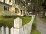 Fence and yard of Victorian house.