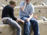 Millennium Quarter Exchange Square couple talking on mobile phones.