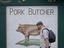 Man walking past pork butcher poster.