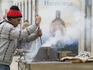 Street vendor on Rua Augusta roasts chestnuts.
