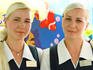 Twin female waiters with long blond hair at seaside bar.