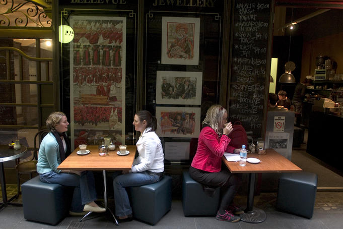 Women having coffee outside cafe in Center Place, city centre.
