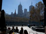 People dining alfresco at Southbank with city high-rises beyond.