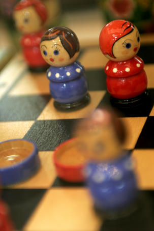 Detail of wooden doll chess set.