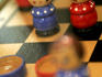 Detail of wooden doll chess set.