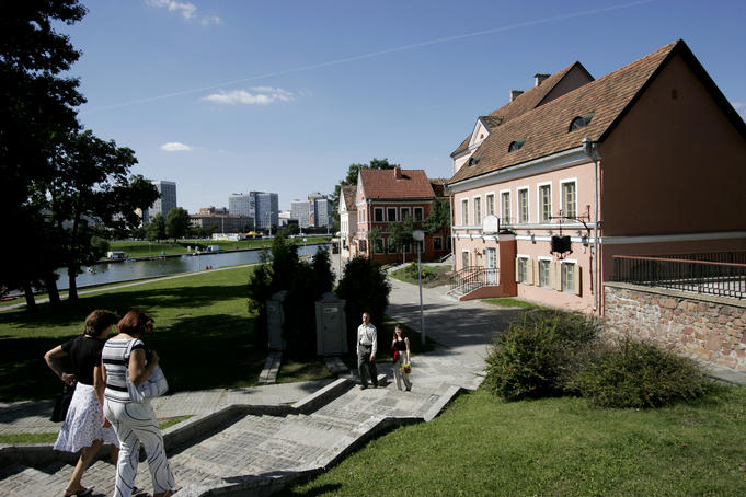 People walking on steps near newly renovated house in 'old town'.