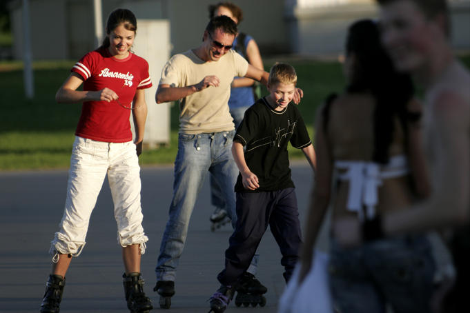 Young people roller blading near Palace of Sports.