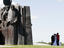 Young couple having their wedding photos taken on Island of Tears (Afghan war memorial).