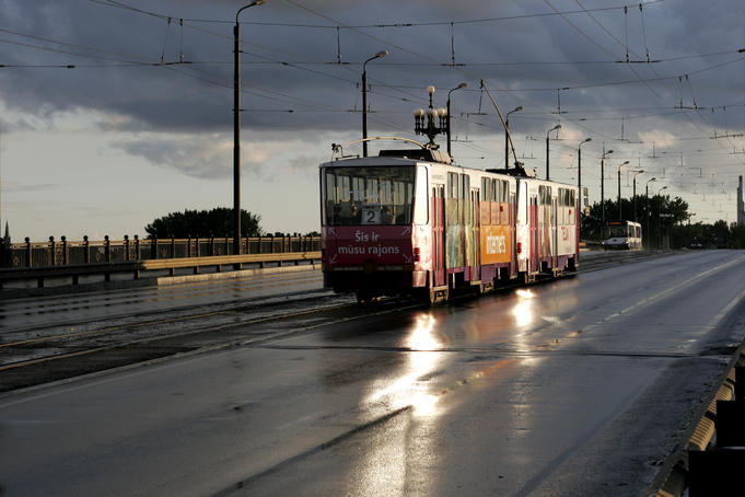 Tram running across Akmens Bridge after thunder storm.