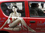 Man driving car with advertisement on Krakow Street.