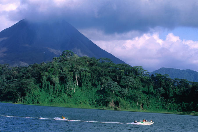 Tropical rain forest, lake with Volcano in background.