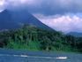 Tropical rain forest, lake with Volcano in background.